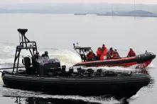 The Royal Canadian Mounted Police Emergency Response Team (front) and the Canadian Coast Guard patroling the surroundings of a mock migrant vessel in Sydney