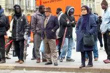 Migrants from Western Africa selling umbrellas on the central plaza in Torino, Italy