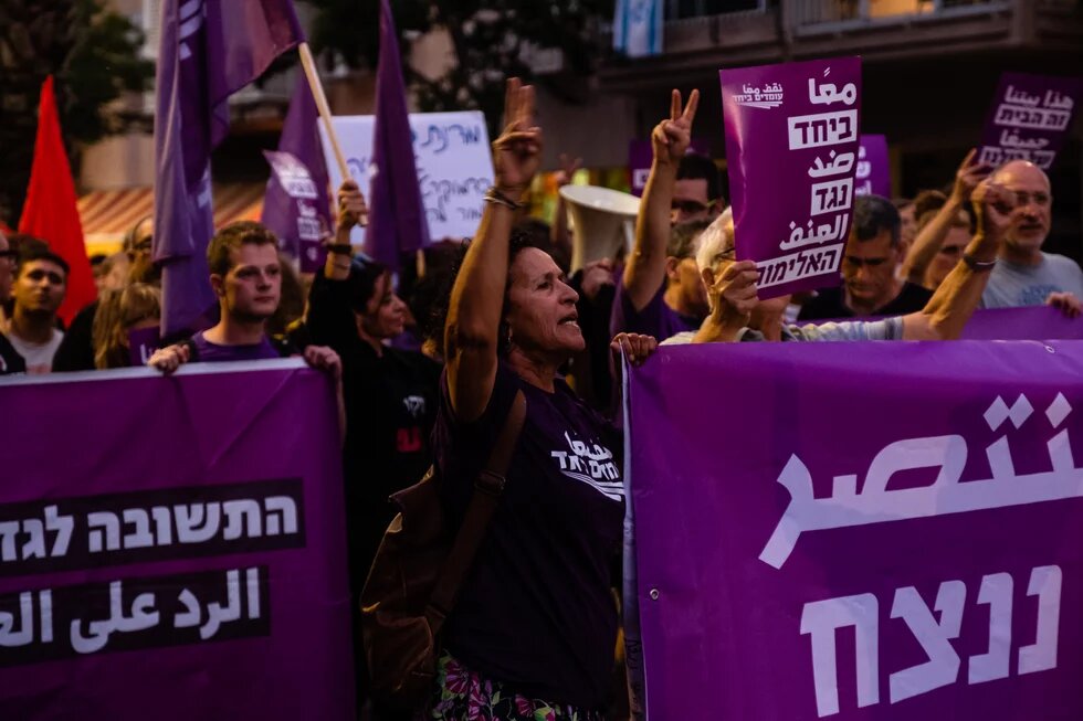 Protestierende halten Transparente mit der Aufschrift "Standing Together" auf Hebräisch hoch, bei einem Protest in Tel Aviv 2021.