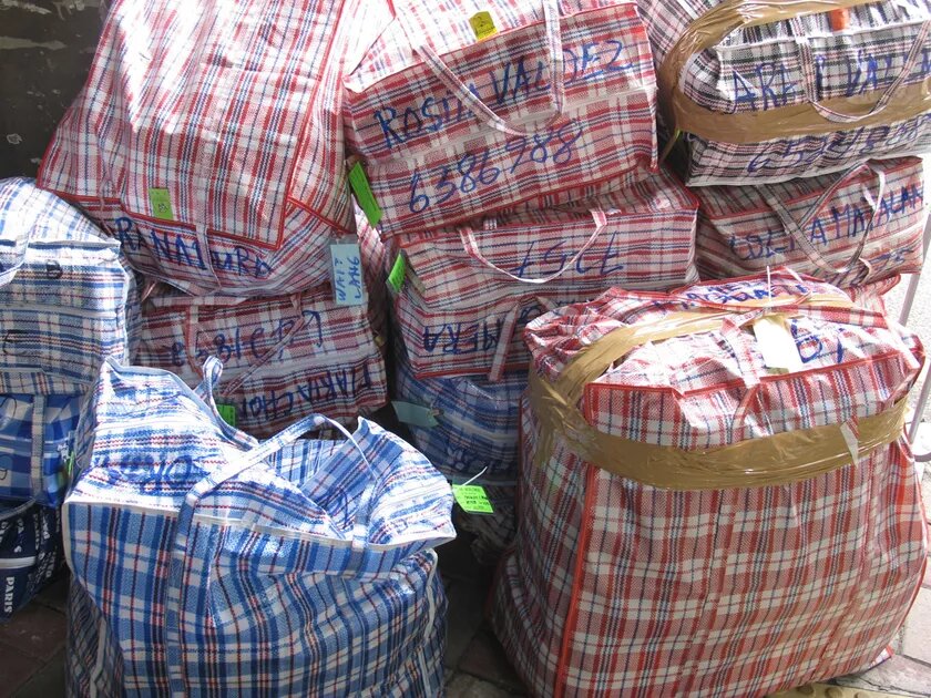 Bags of labour migrants on their way to the shipping container